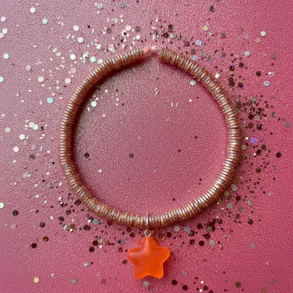 Bracelet with a star charm on a pink glittery background